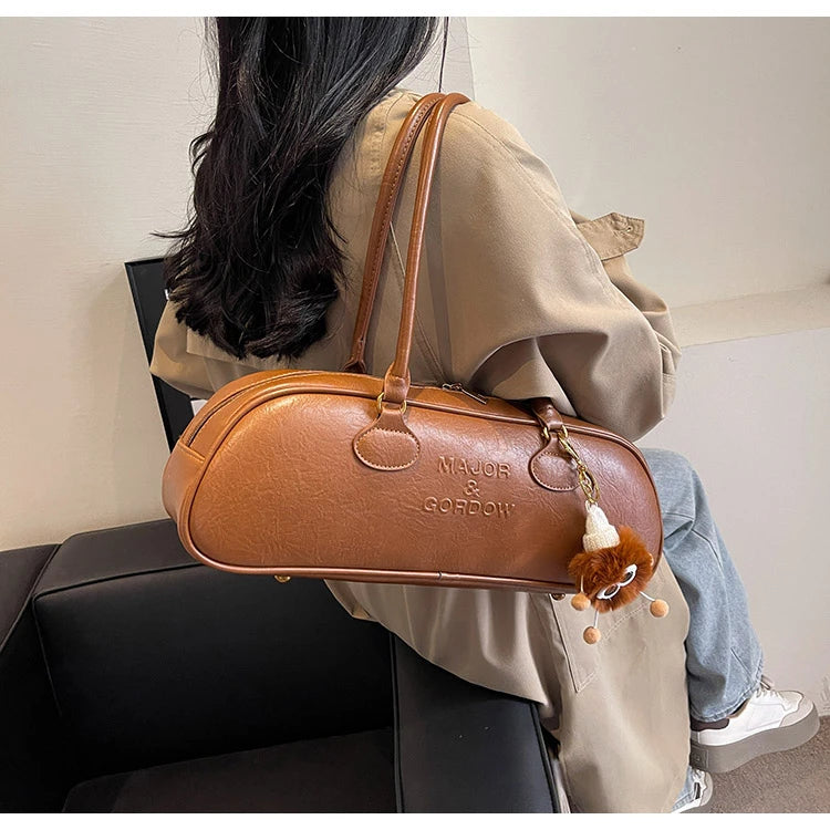 Stitched Pillow-Shape Shoulder Bag 
Trendy zippered handbag with a soft, structured design. Versatile for shoulder or hand carry perfect for everyday style.