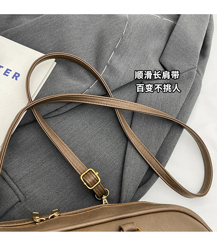 Stitched Pillow-Shape Shoulder Bag 
Trendy zippered handbag with a soft, structured design. Versatile for shoulder or hand carry perfect for everyday style.