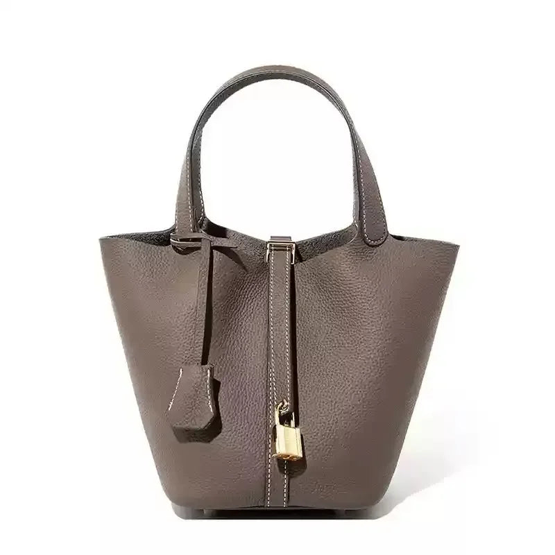 Women’s Leather Bucket Handbag A soft, stylish summer essential featuring a modern basket design with a convenient mobile phone pocket.