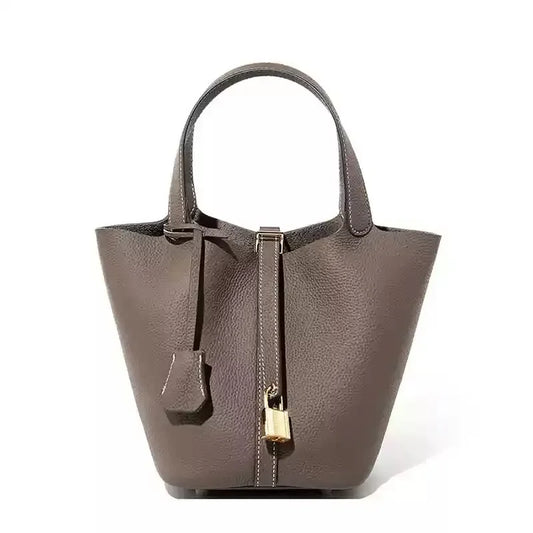 Women’s Leather Bucket Handbag A soft, stylish summer essential featuring a modern basket design with a convenient mobile phone pocket.