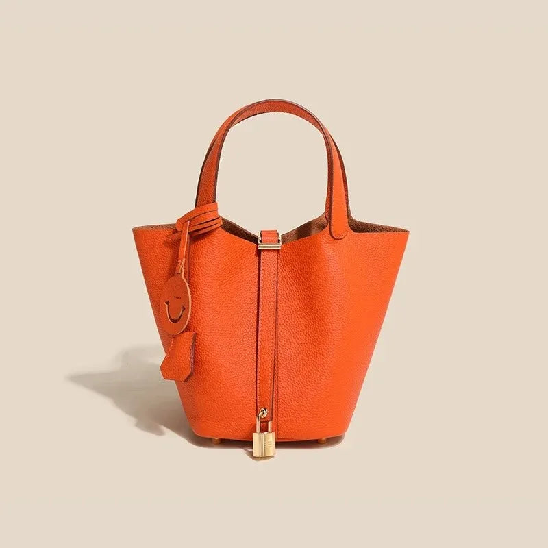 Women’s Leather Bucket Handbag A soft, stylish summer essential featuring a modern basket design with a convenient mobile phone pocket.