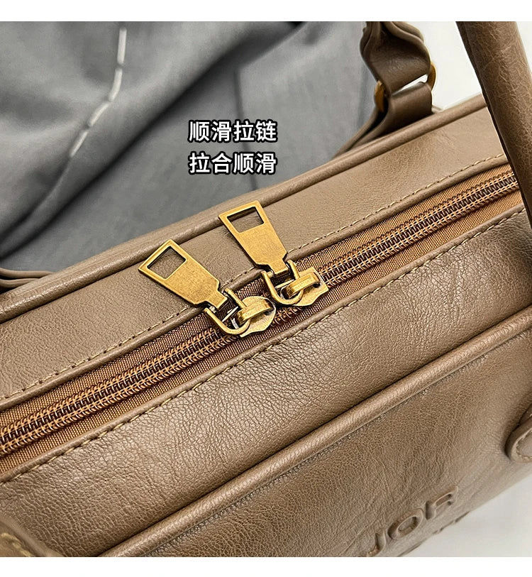 Stitched Pillow-Shape Shoulder Bag 
Trendy zippered handbag with a soft, structured design. Versatile for shoulder or hand carry perfect for everyday style.