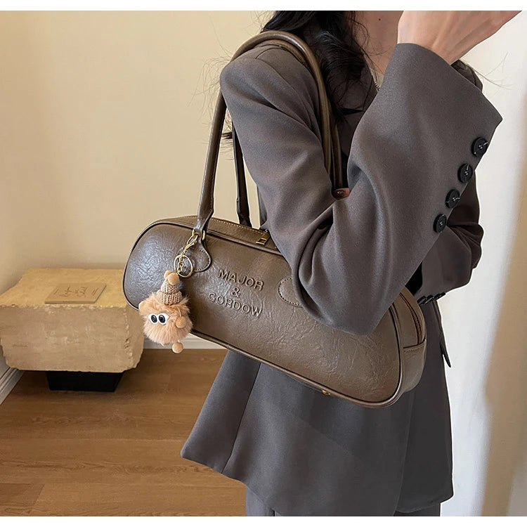 Stitched Pillow-Shape Shoulder Bag 
Trendy zippered handbag with a soft, structured design. Versatile for shoulder or hand carry perfect for everyday style.