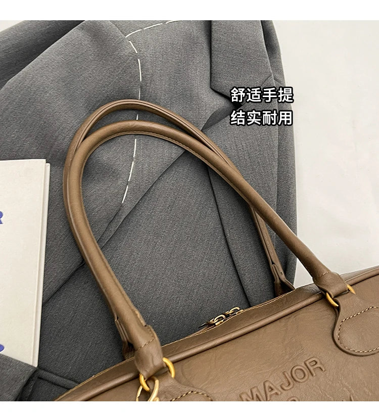 Stitched Pillow-Shape Shoulder Bag 
Trendy zippered handbag with a soft, structured design. Versatile for shoulder or hand carry perfect for everyday style.