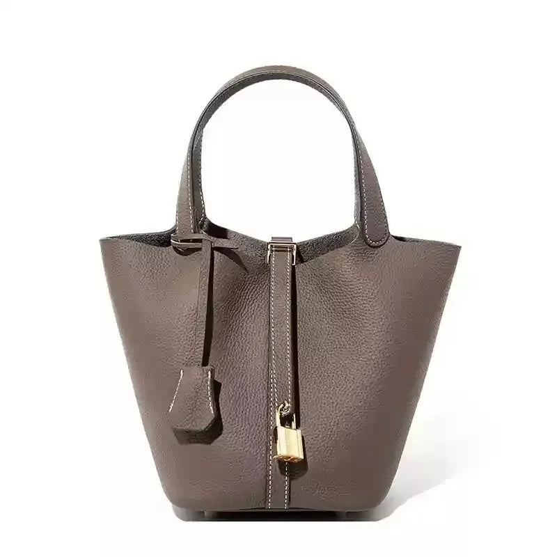Women’s Leather Bucket Handbag A soft, stylish summer essential featuring a modern basket design with a convenient mobile phone pocket.