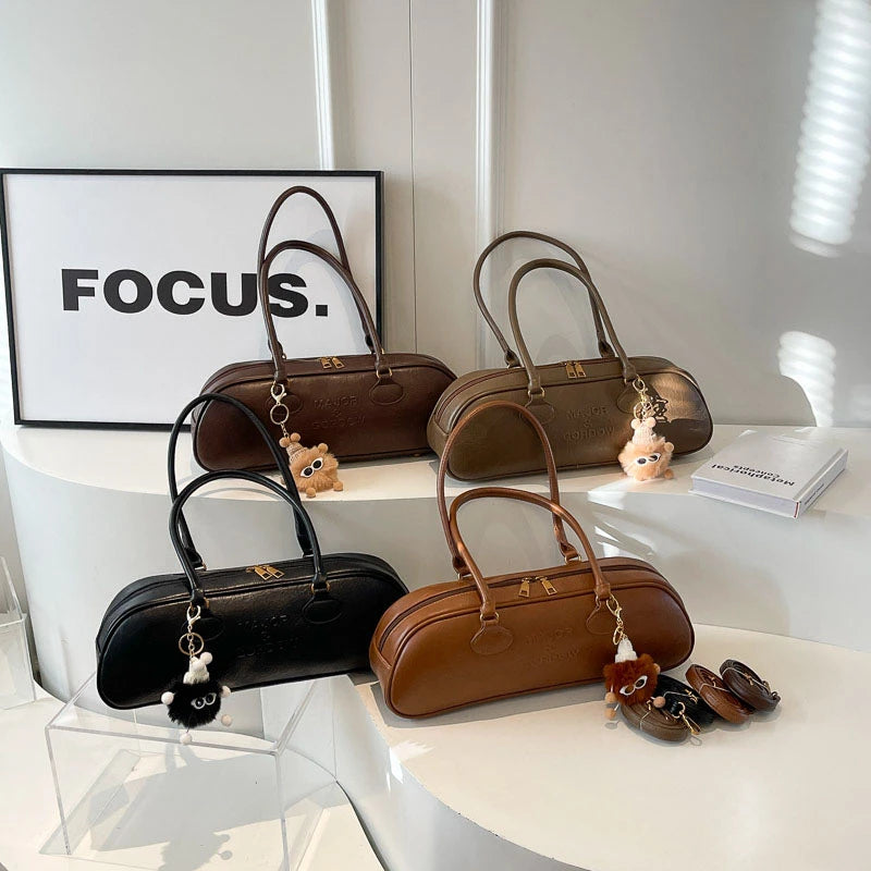 Stitched Pillow-Shape Shoulder Bag 
Trendy zippered handbag with a soft, structured design. Versatile for shoulder or hand carry perfect for everyday style.