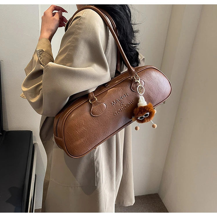 Stitched Pillow-Shape Shoulder Bag 
Trendy zippered handbag with a soft, structured design. Versatile for shoulder or hand carry perfect for everyday style.