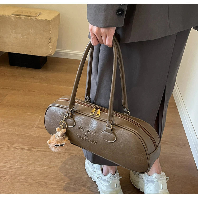 Stitched Pillow-Shape Shoulder Bag 
Trendy zippered handbag with a soft, structured design. Versatile for shoulder or hand carry perfect for everyday style.