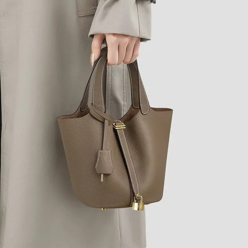 Women’s Leather Bucket Handbag A soft, stylish summer essential featuring a modern basket design with a convenient mobile phone pocket.