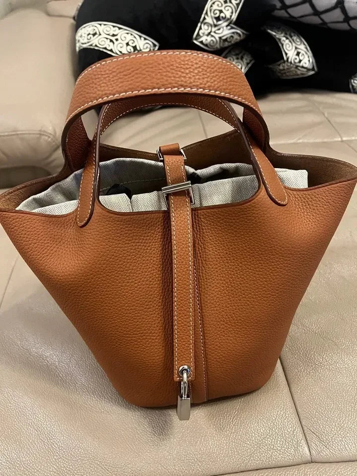 Women’s Leather Bucket Handbag A soft, stylish summer essential featuring a modern basket design with a convenient mobile phone pocket.