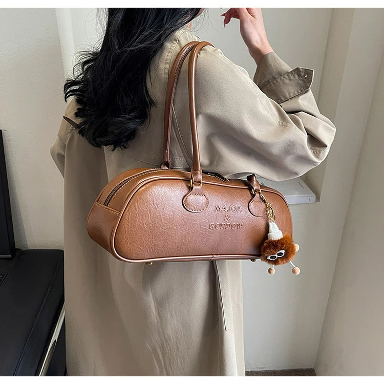 Stitched Pillow-Shape Shoulder Bag 
Trendy zippered handbag with a soft, structured design. Versatile for shoulder or hand carry perfect for everyday style.