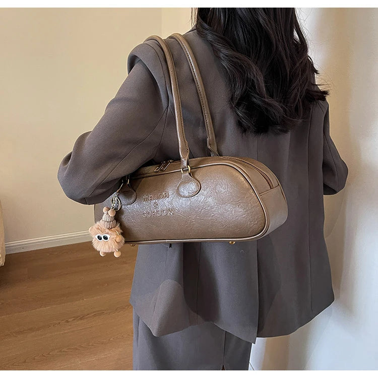 Stitched Pillow-Shape Shoulder Bag 
Trendy zippered handbag with a soft, structured design. Versatile for shoulder or hand carry perfect for everyday style.