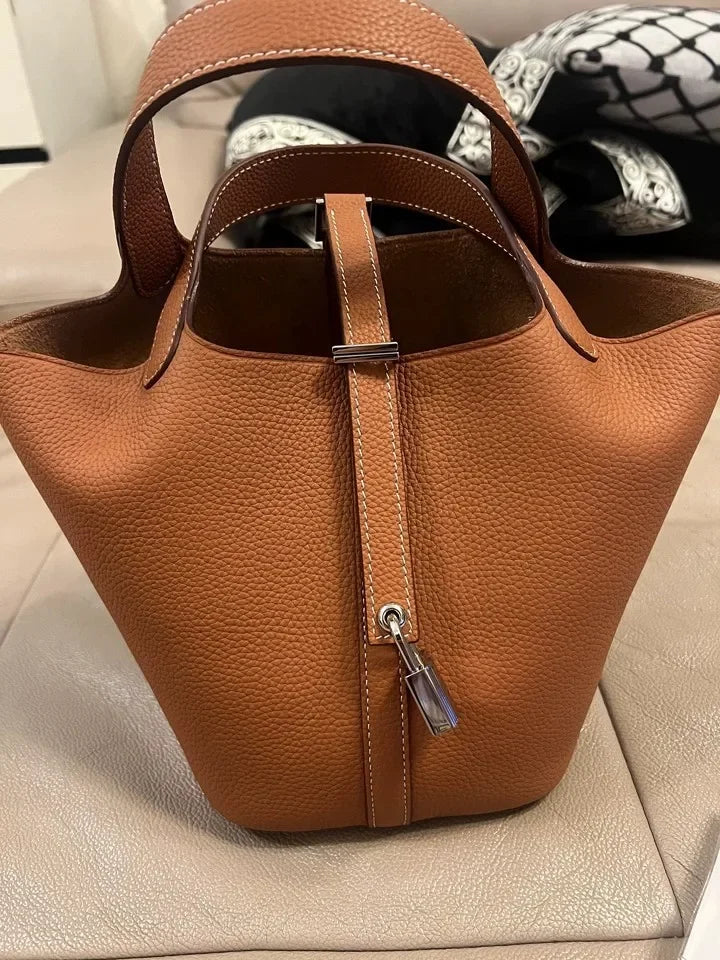 Women’s Leather Bucket Handbag A soft, stylish summer essential featuring a modern basket design with a convenient mobile phone pocket.