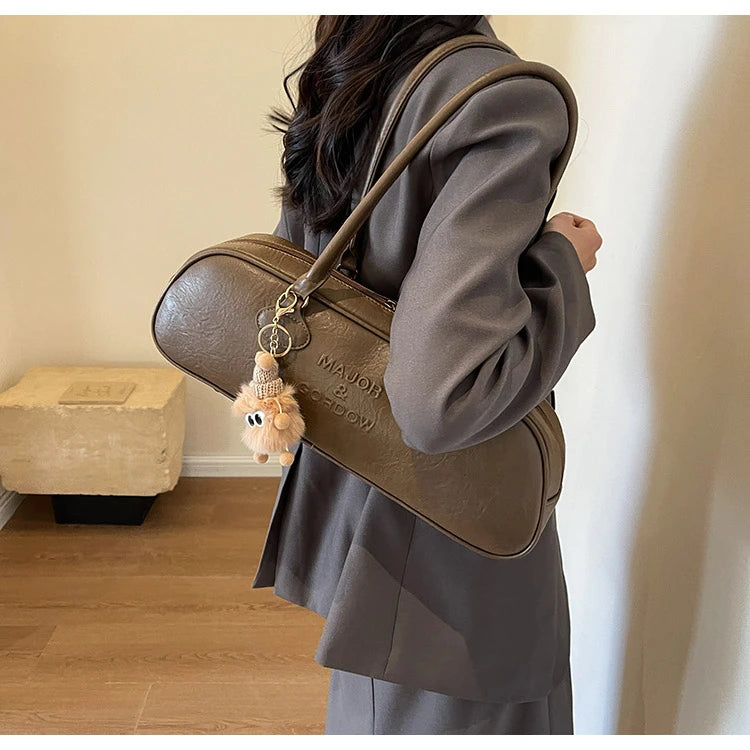 Stitched Pillow-Shape Shoulder Bag 
Trendy zippered handbag with a soft, structured design. Versatile for shoulder or hand carry perfect for everyday style.