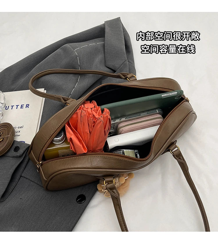 Stitched Pillow-Shape Shoulder Bag 
Trendy zippered handbag with a soft, structured design. Versatile for shoulder or hand carry perfect for everyday style.