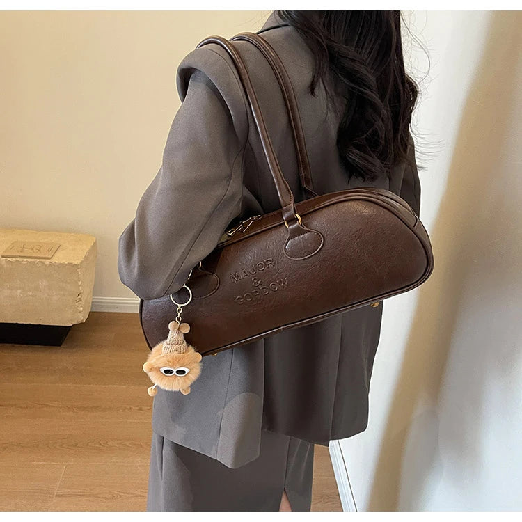 Stitched Pillow-Shape Shoulder Bag 
Trendy zippered handbag with a soft, structured design. Versatile for shoulder or hand carry perfect for everyday style.