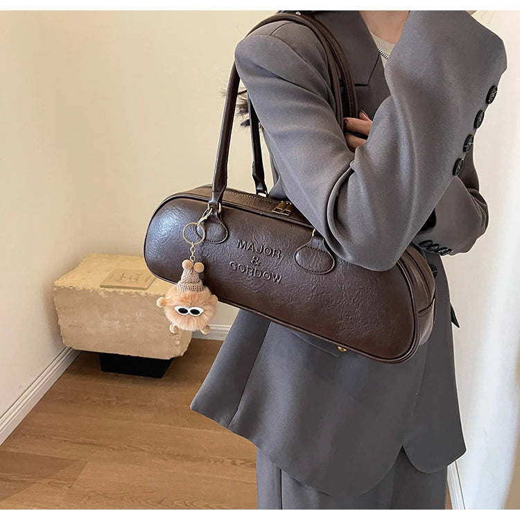 Stitched Pillow-Shape Shoulder Bag 
Trendy zippered handbag with a soft, structured design. Versatile for shoulder or hand carry perfect for everyday style.